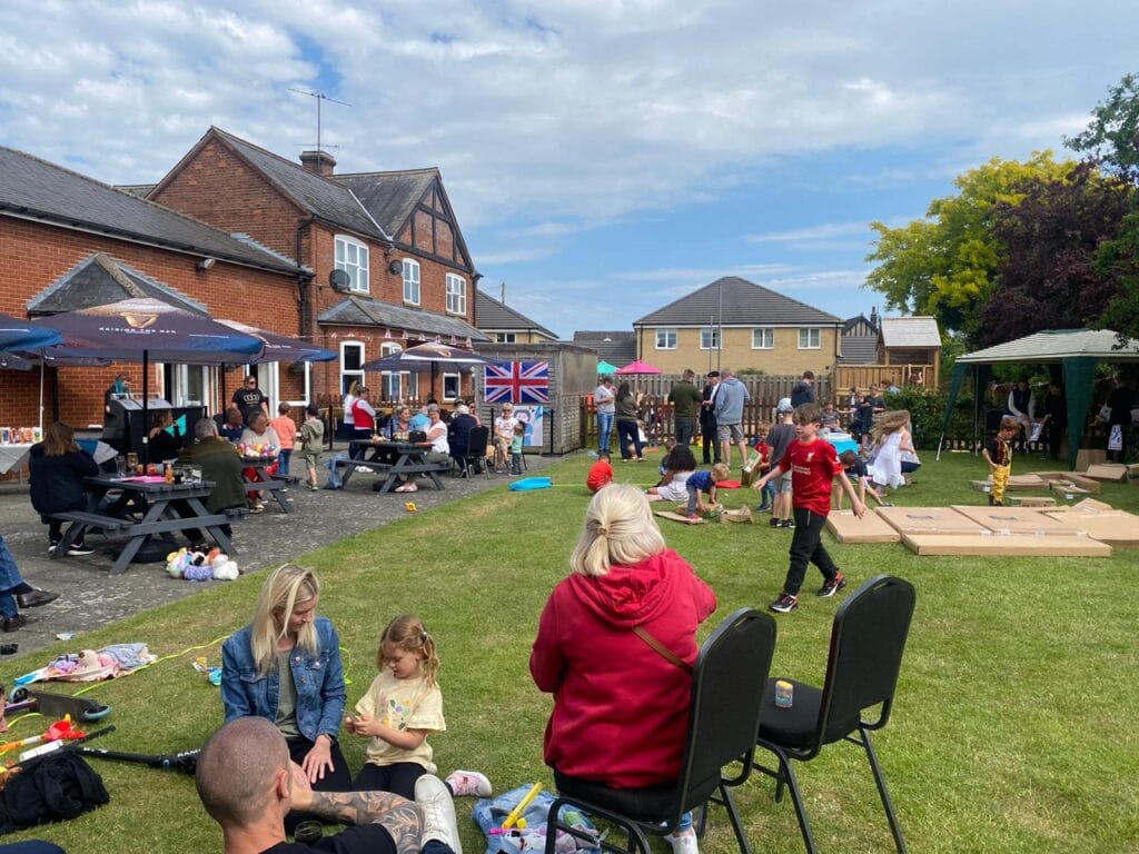 Community outdoor event with families and children playing