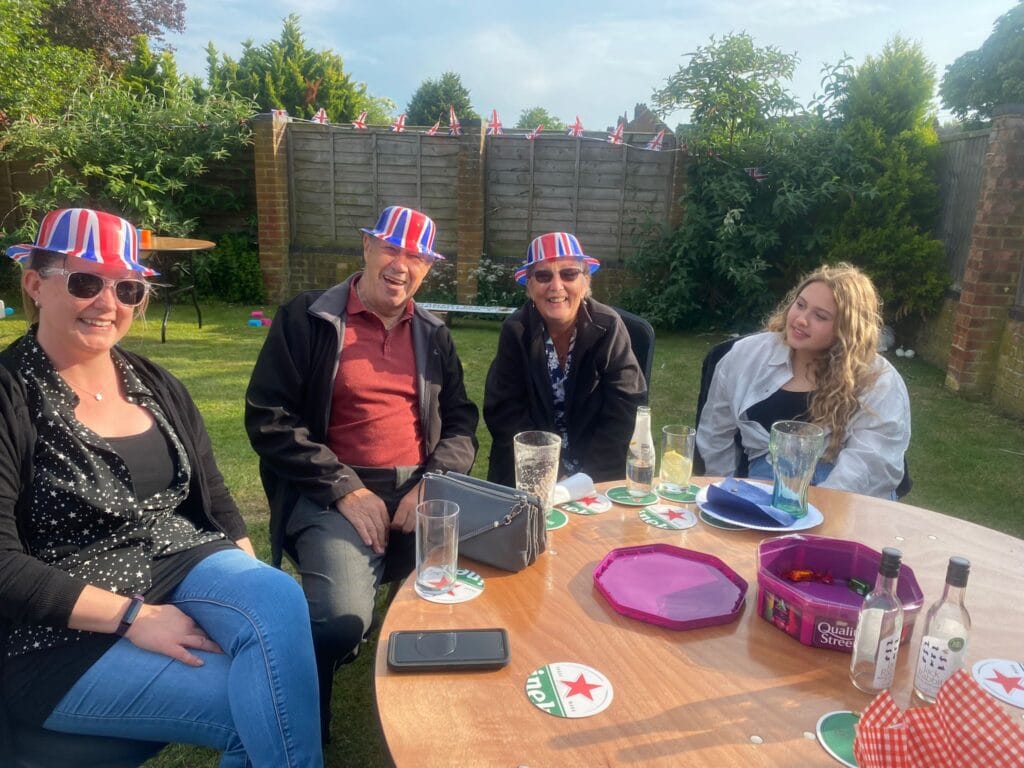 People wearing Union Jack hats at garden party