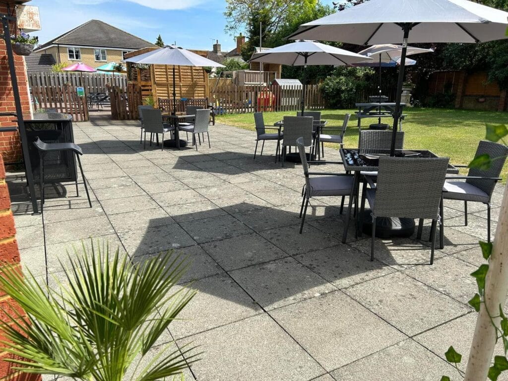 Outdoor patio with tables, chairs and umbrellas