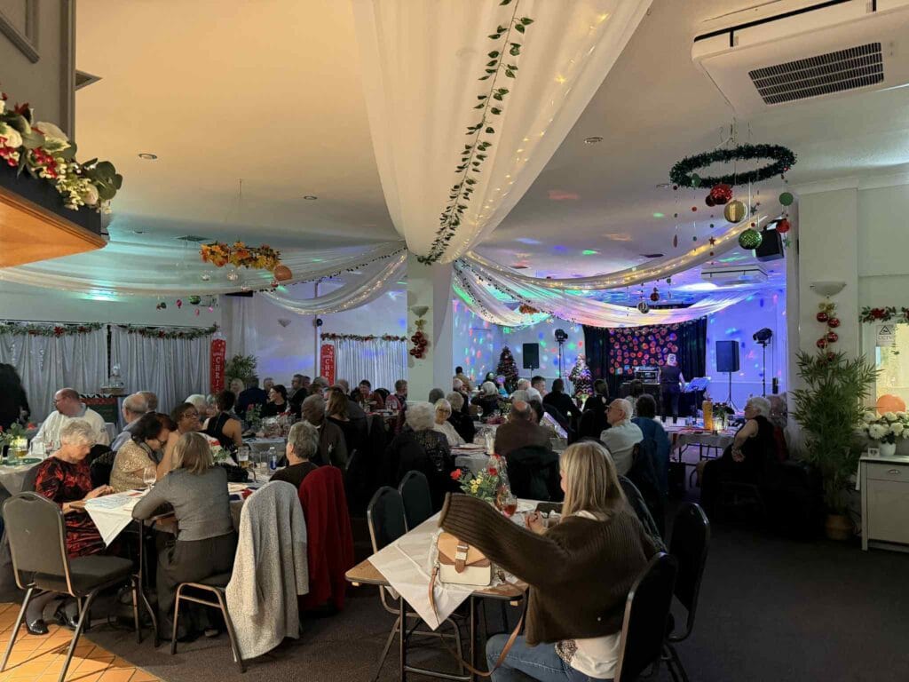 People enjoying festive dinner with live music performance