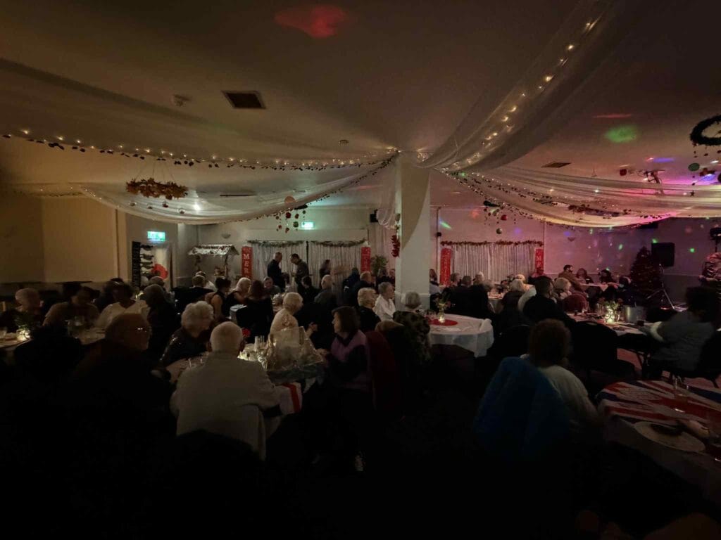People enjoying festive dinner with Christmas decorations