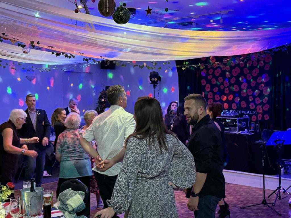 People dancing at a festive party with decorations