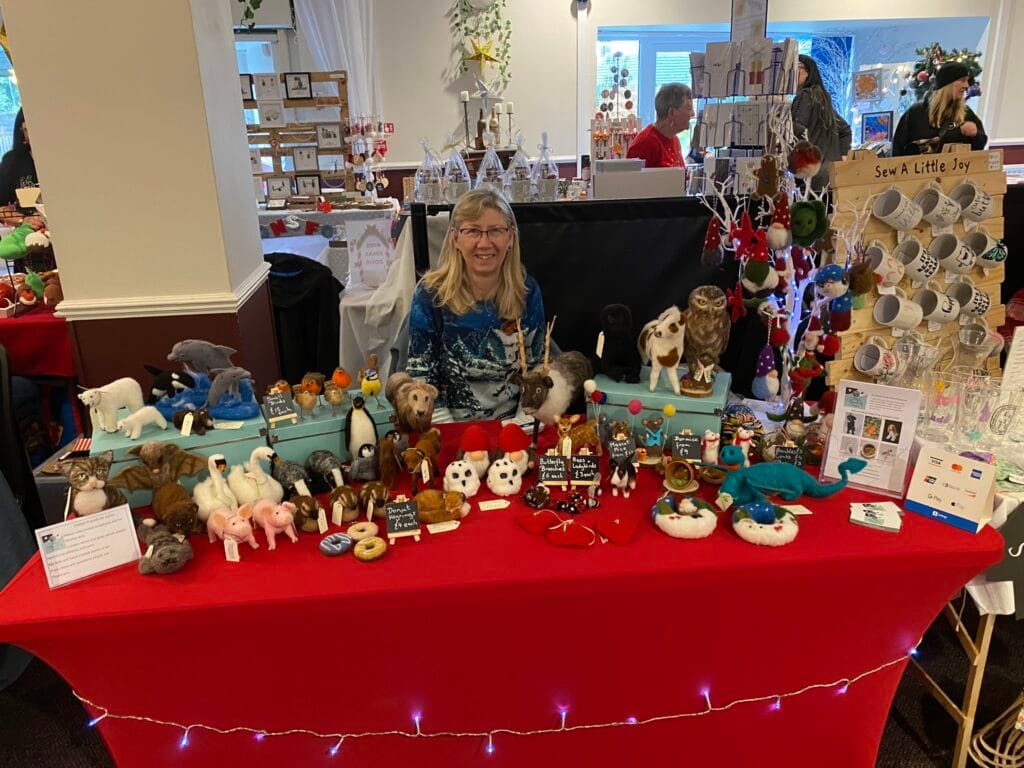 Craft fair stall displaying handmade felt animal toys