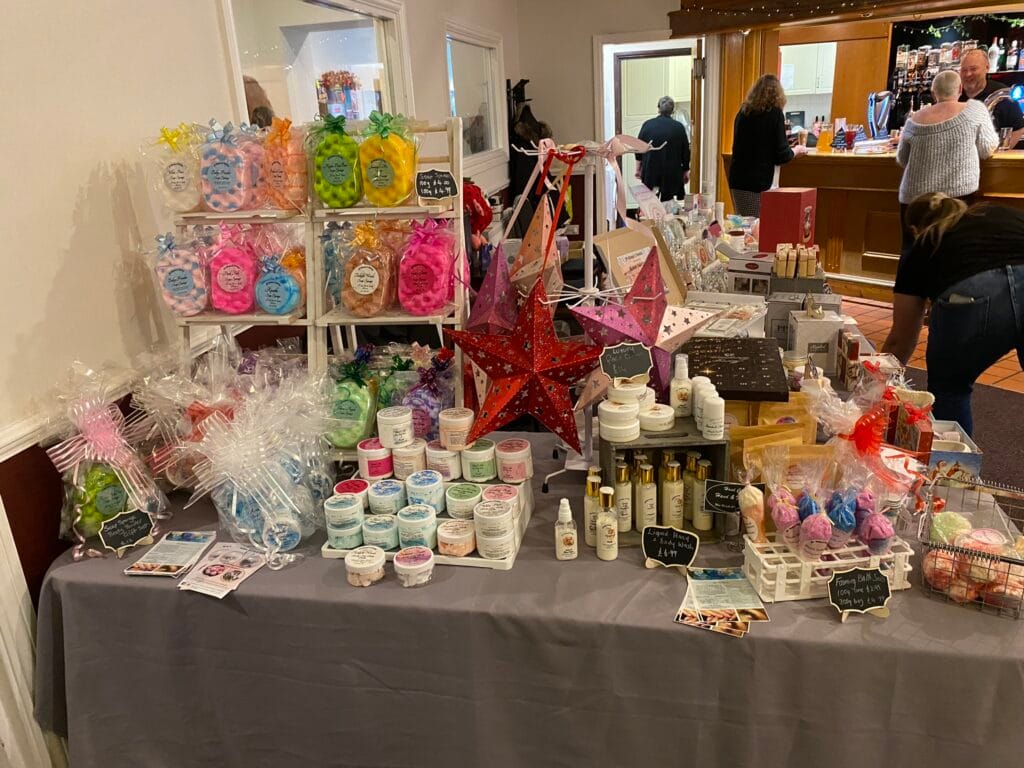 Market stall displaying handmade bath and beauty products