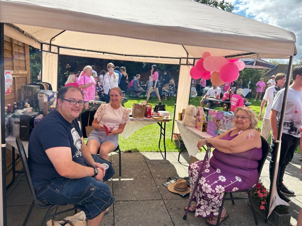 People enjoying a community summer fair outdoors