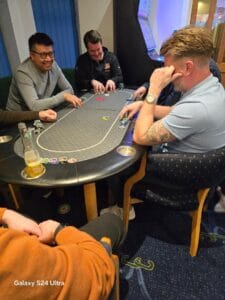 Friends playing poker at a casino table