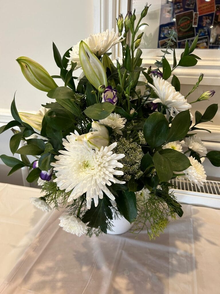 White and green floral arrangement in vase