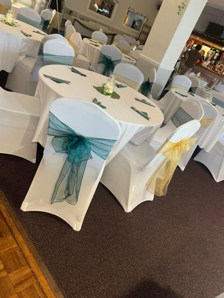 Elegant banquet tables with white covers and ribbons