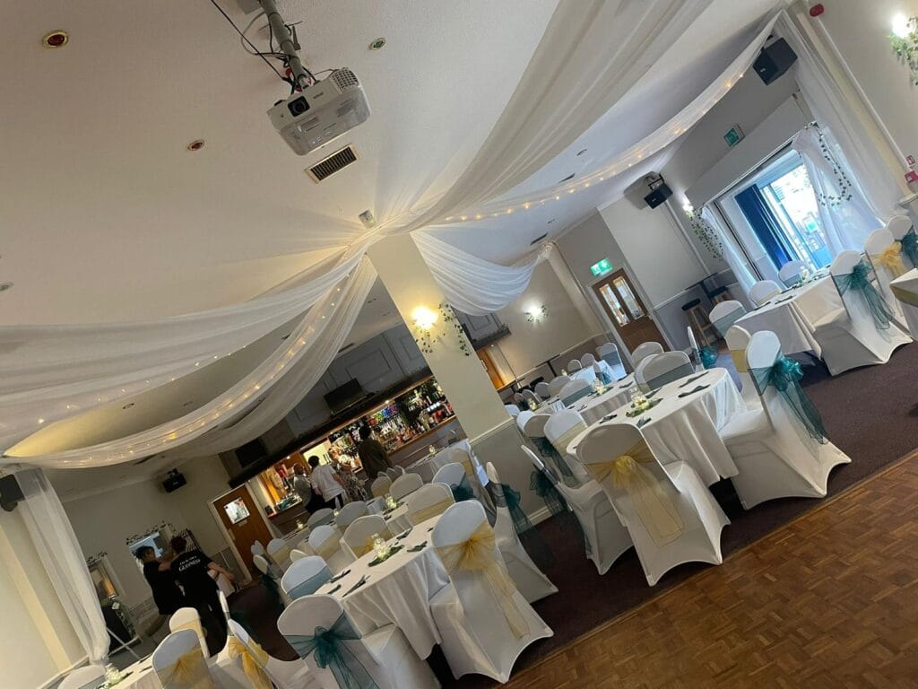 Elegant wedding reception hall with decorated round tables