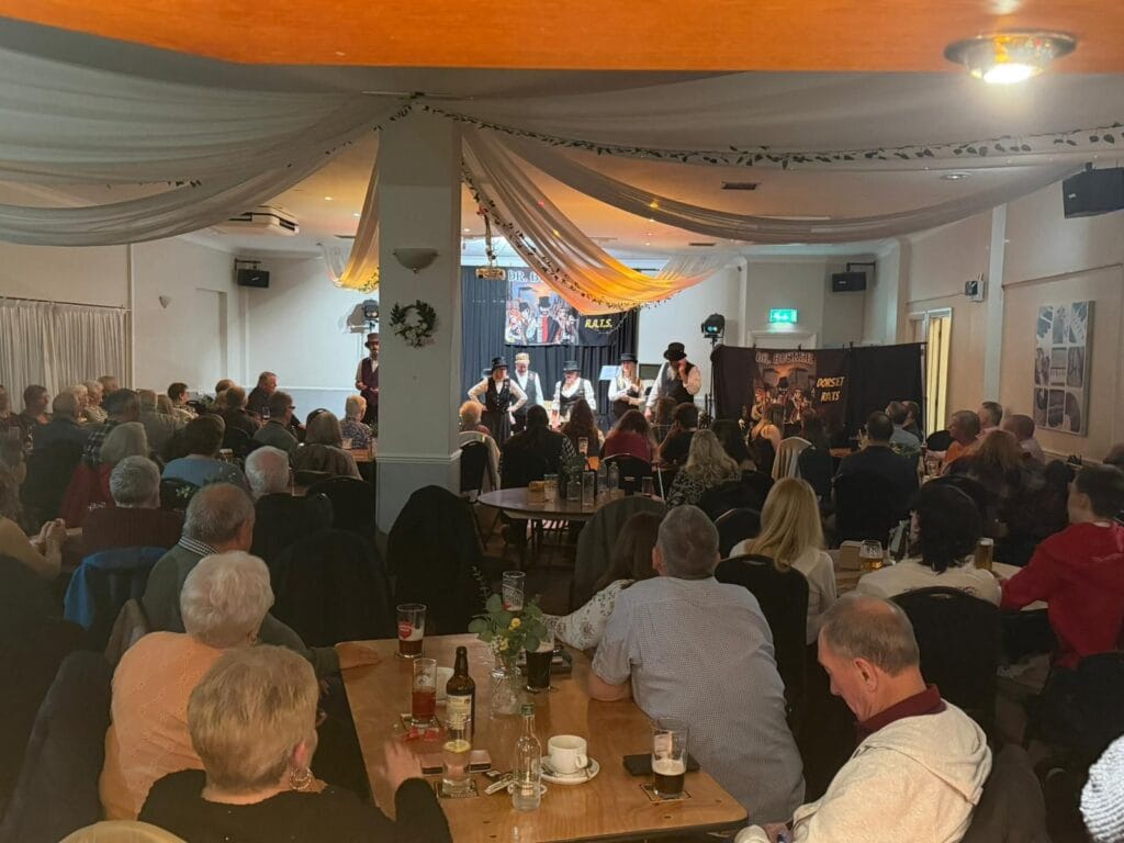 Audience watching live band performance in pub venue